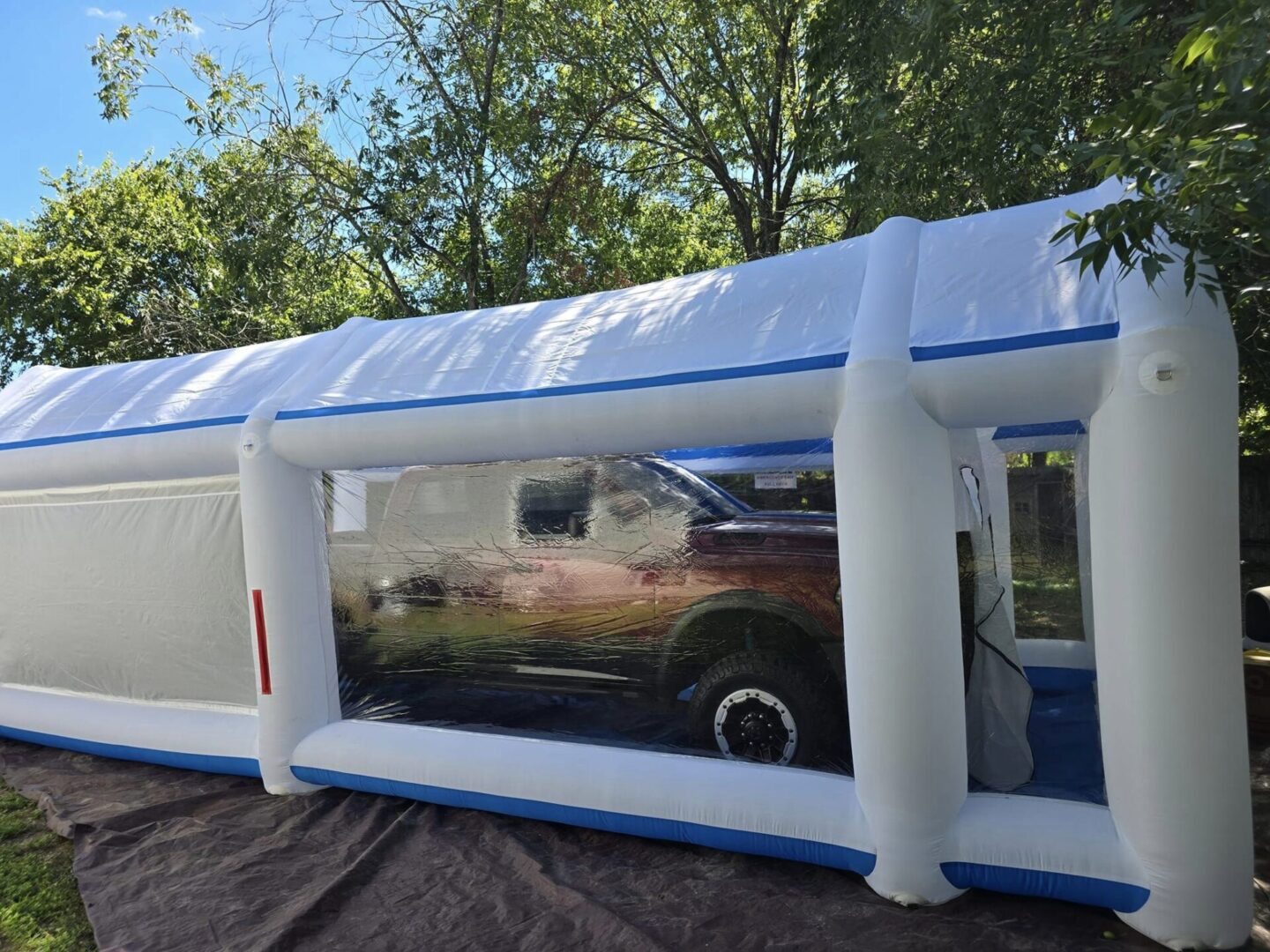 A car is in the middle of an inflatable tent.