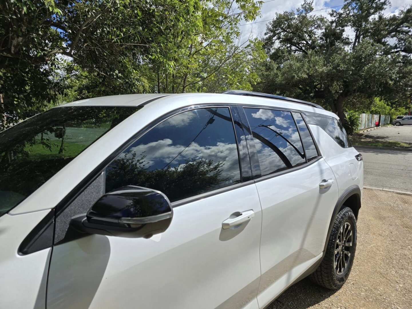 A white car parked on the side of a road.