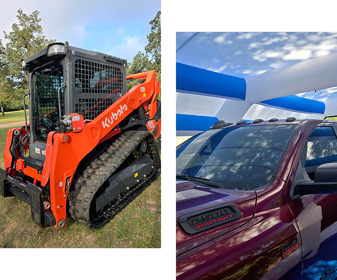 A red and black tractor is parked next to a purple truck