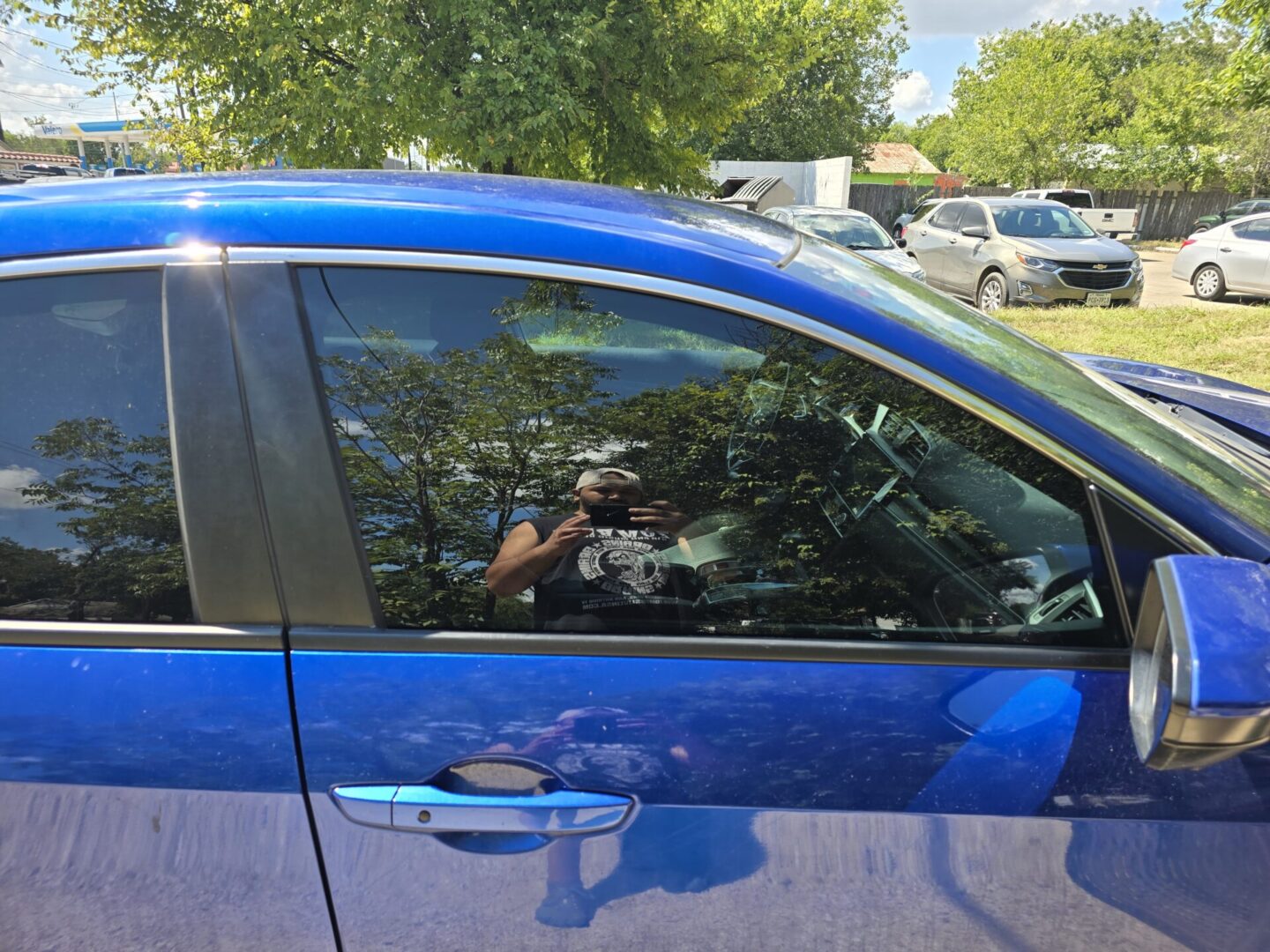 A person taking a picture of the outside of their car.